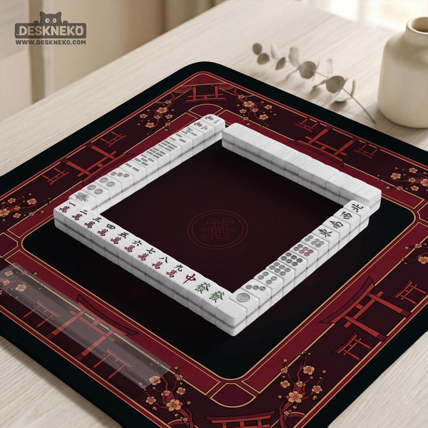 Square burgundy mahjong mat with a cherry blossom floral border and a dark open center.