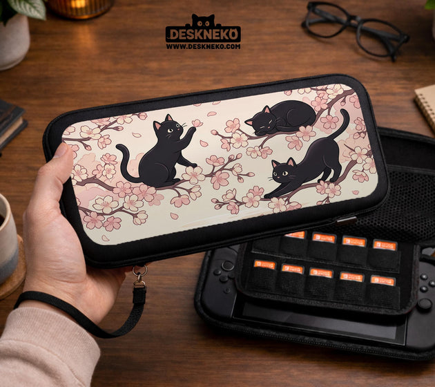 Switch case with black cats and cherry blossoms on a light pastel background.