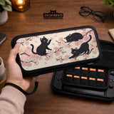 Switch case with black cats and cherry blossoms on a light pastel background.