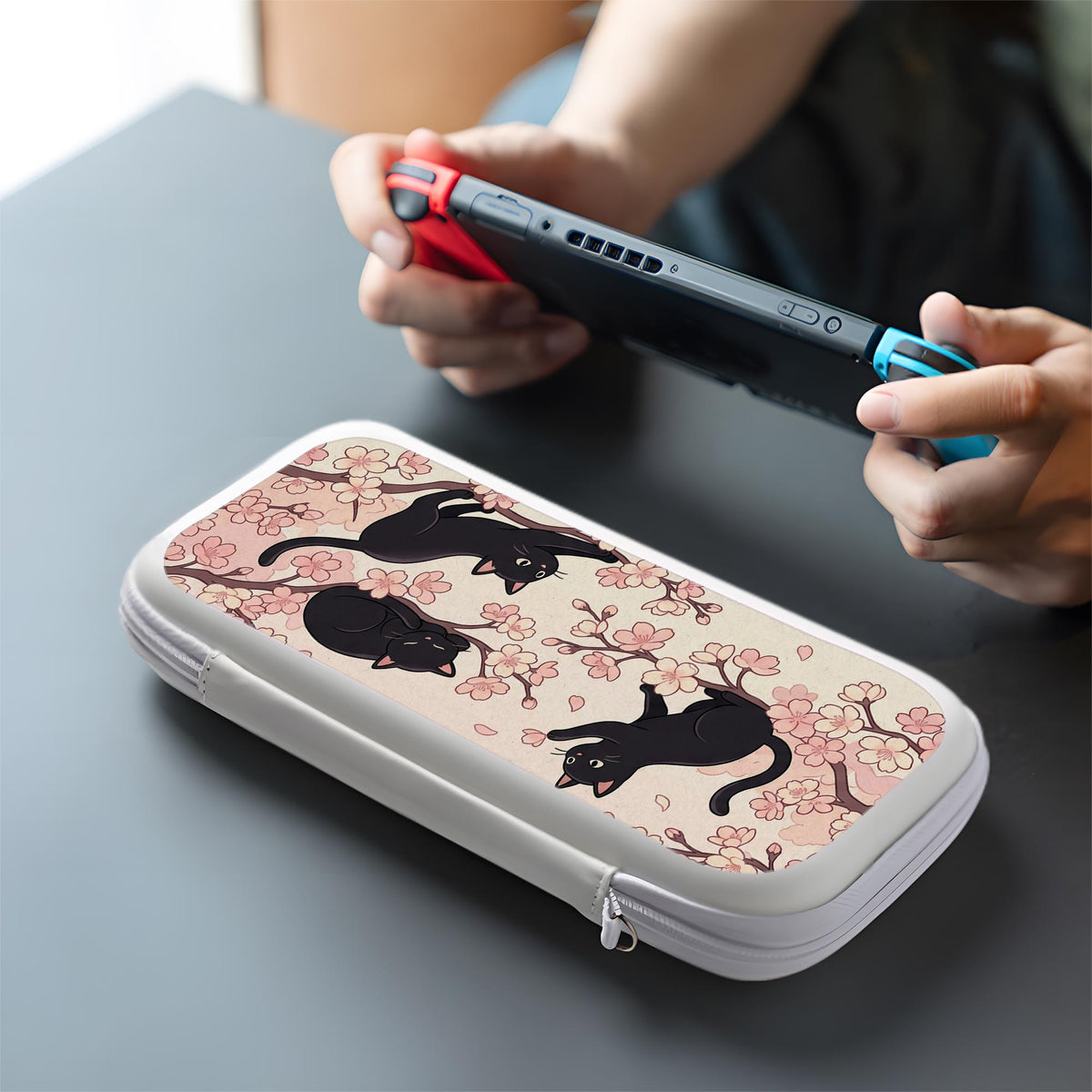 Switch case with black cats and cherry blossoms on a light pastel background.