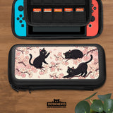 Switch case with black cats and cherry blossoms on a light pastel background.