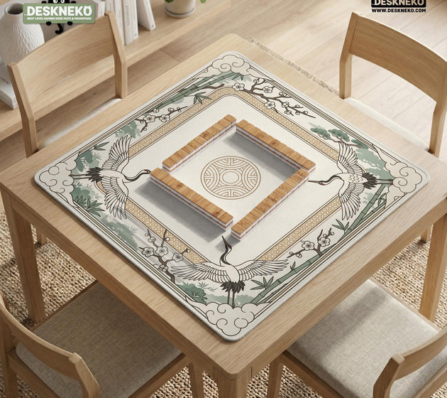 Square mahjong table mat with a cream center and a border design of cranes, bamboo, plum blossoms, and a geometric frame in sage green and warm gold.