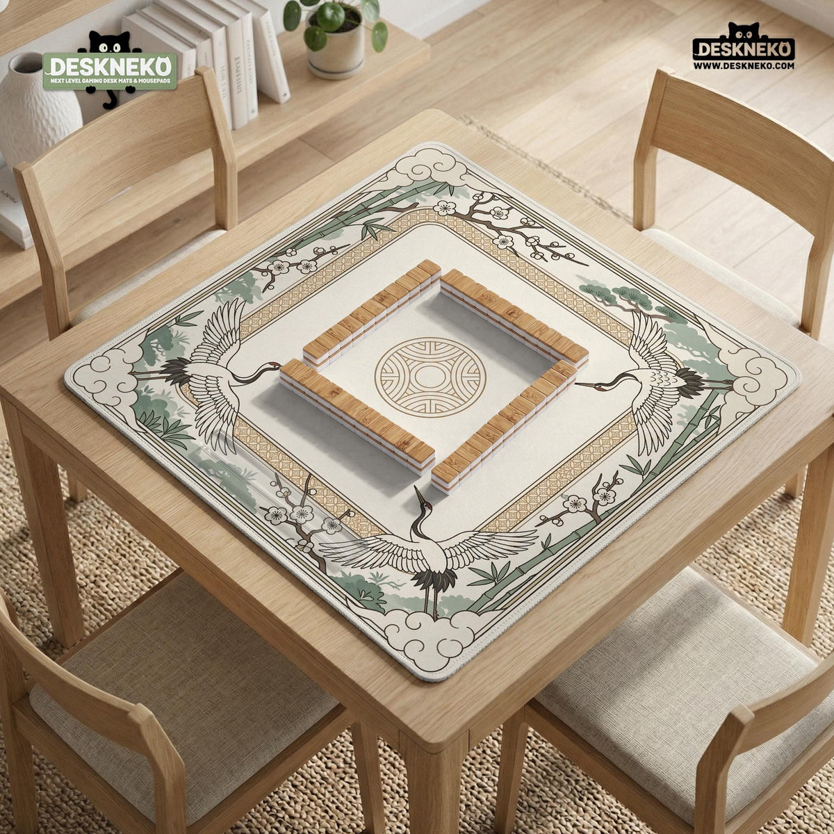 Square mahjong table mat with a cream center and a border design of cranes, bamboo, plum blossoms, and a geometric frame in sage green and warm gold.