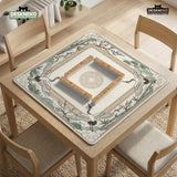 Square mahjong table mat with a cream center and a border design of cranes, bamboo, plum blossoms, and a geometric frame in sage green and warm gold.