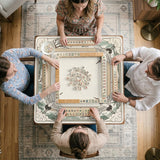 Square mahjong table mat with a cream center and a border design of cranes, bamboo, plum blossoms, and a geometric frame in sage green and warm gold.