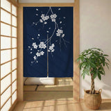 Navy door curtain with pink cherry blossom branches and a light floral layout on a dark background.