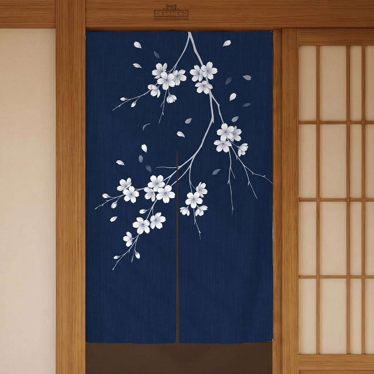 Navy door curtain with pink cherry blossom branches and a light floral layout on a dark background.