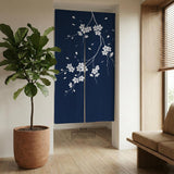 Navy door curtain with pink cherry blossom branches and a light floral layout on a dark background.