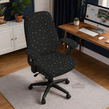 Desk chair cover in black with a small gold star pattern shown on a swivel chair.