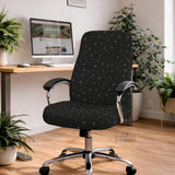 Desk chair cover in black with a small gold star pattern shown on a swivel chair.