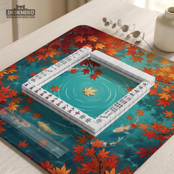 Square teal mahjong mat with koi fish, falling autumn leaves, and pond water artwork.