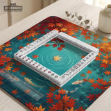 Square teal mahjong mat with koi fish, falling autumn leaves, and pond water artwork.