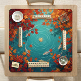 Square teal mahjong mat with koi fish, falling autumn leaves, and pond water artwork.