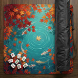 Square teal mahjong mat with koi fish, falling autumn leaves, and pond water artwork.