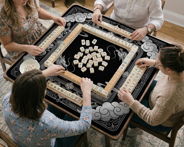 Square mahjong table mat with a black and silver dragon border, cloud details, and a scalloped edge.