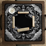 Square mahjong table mat with a black and silver dragon border, cloud details, and a scalloped edge.