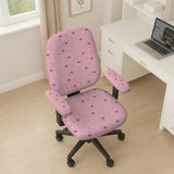 Pink chair cover with a pattern of moons, stars, bows, and small decorative shapes on a chair with armrests.
