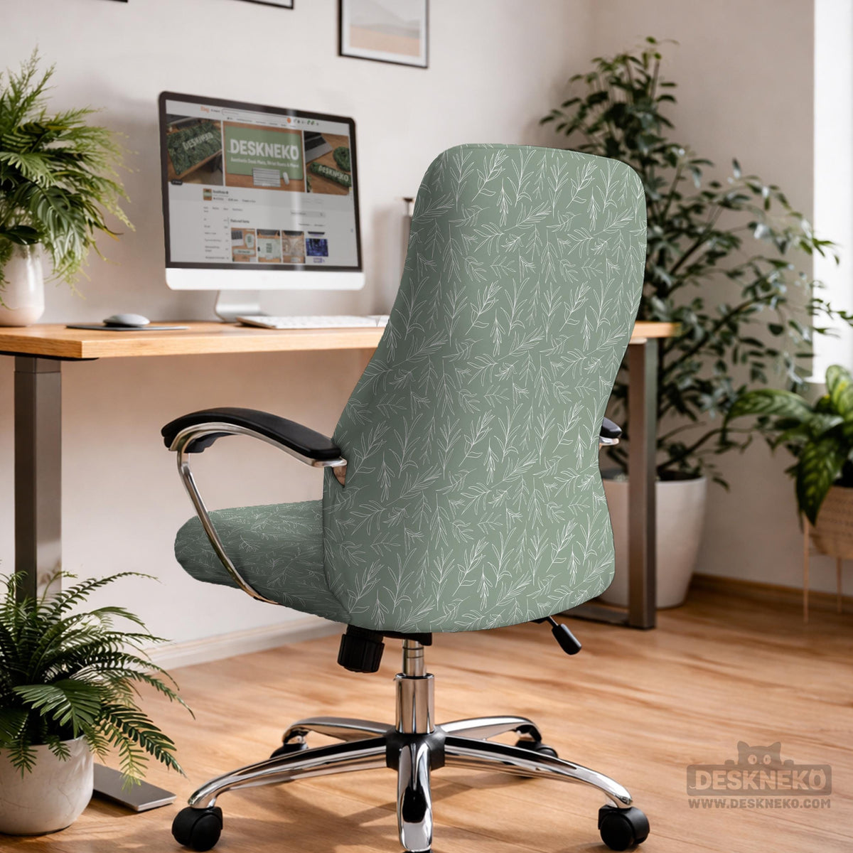 Office chair cover in muted sage green with a light leaf pattern on a white background.