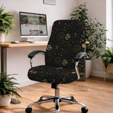 Black chair cover with a dark galaxy pattern, muted gold stars and celestial artwork on a chair.