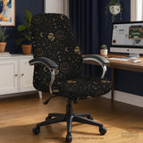 Black chair cover with a dark galaxy pattern, muted gold stars and celestial artwork on a chair.