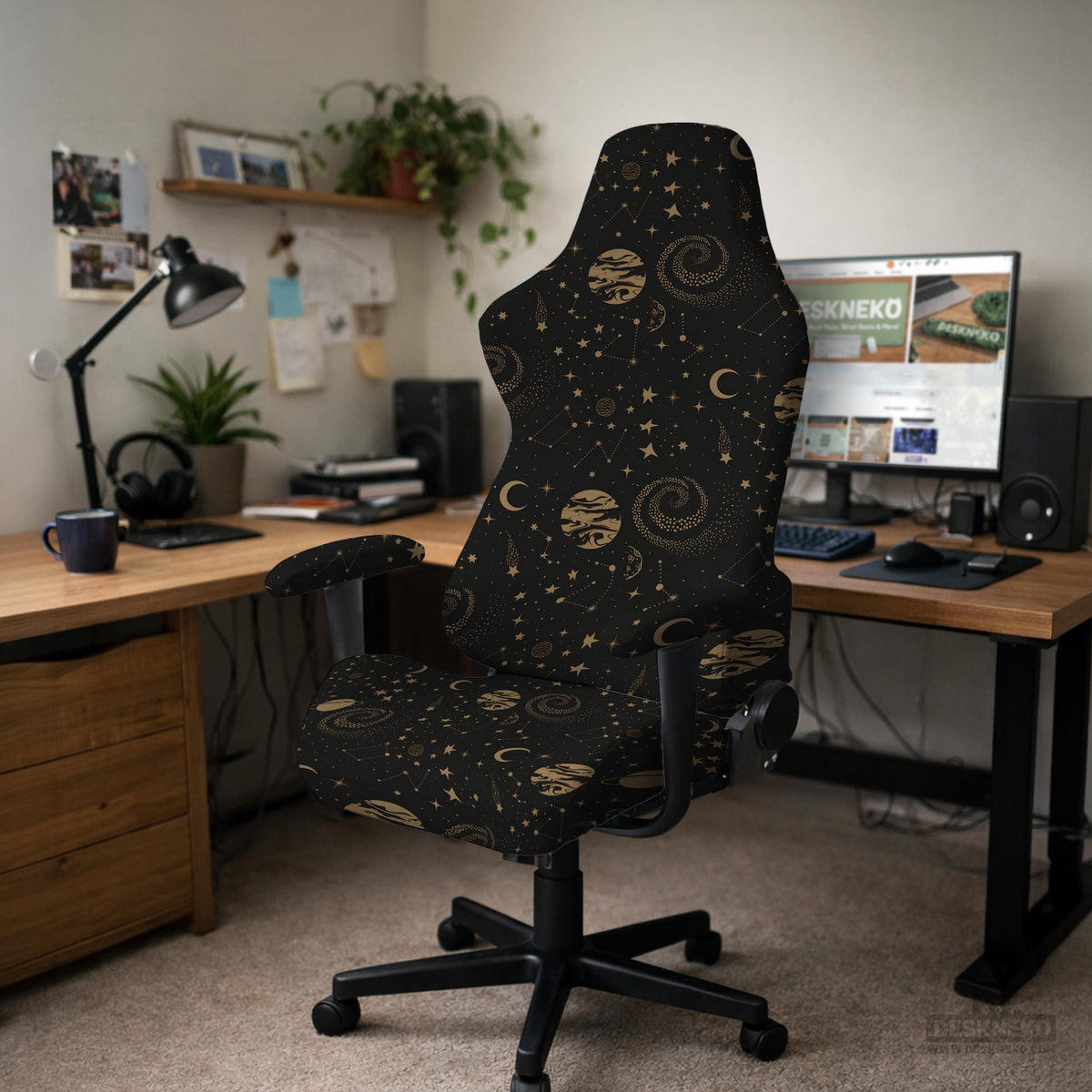 Black chair cover with a dark galaxy pattern, muted gold stars and celestial artwork on a chair.