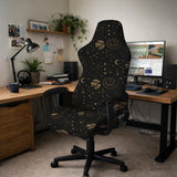 Black chair cover with a dark galaxy pattern, muted gold stars and celestial artwork on a chair.