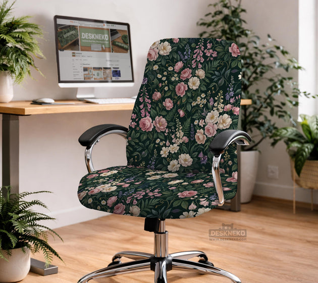 Green chair cover with a dark floral pattern, pink roses, cream flowers, and leafy botanical details on an office chair.