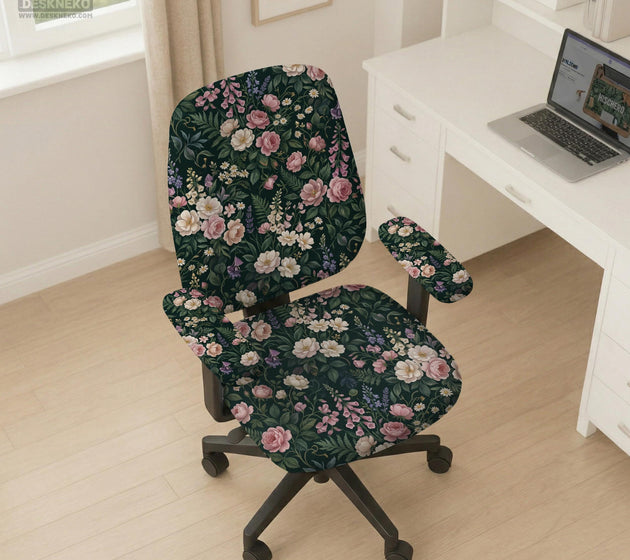 Green chair cover with a dark floral pattern, pink roses, cream flowers, and leafy botanical details on an office chair.