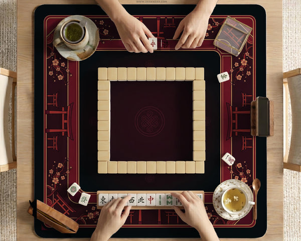 Square burgundy mahjong mat with a cherry blossom floral border and a dark open center.