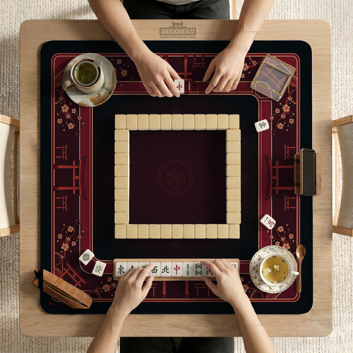Square burgundy mahjong mat with a cherry blossom floral border and a dark open center.