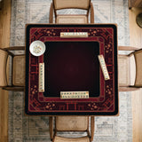 Square burgundy mahjong mat with a cherry blossom floral border and a dark open center.