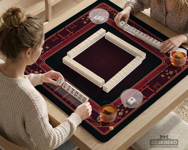 Square burgundy mahjong mat with a cherry blossom floral border and a dark open center.
