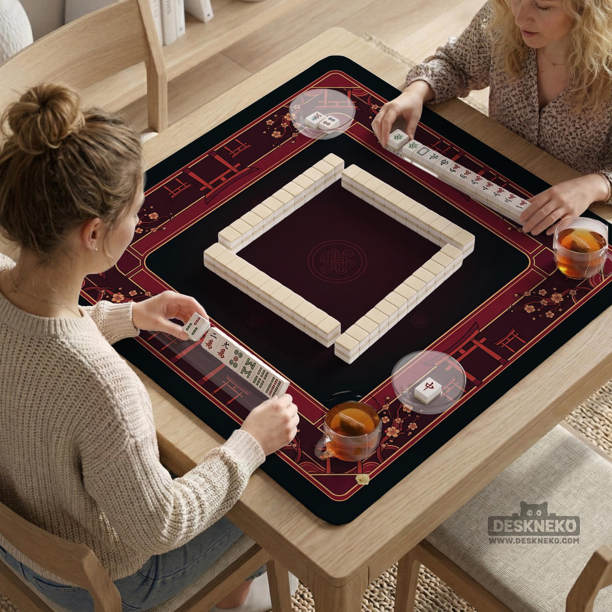 Square burgundy mahjong mat with a cherry blossom floral border and a dark open center.