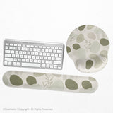 Green abstract botanical mouse pad with a rounded organic pattern and matching keyboard wrist rest option.