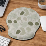 Green abstract botanical mouse pad with a rounded organic pattern and matching keyboard wrist rest option.
