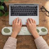 Green abstract botanical mouse pad with a rounded organic pattern and matching keyboard wrist rest option.