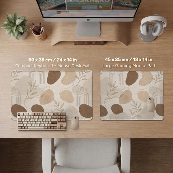 Beige desk mat with fine botanical line drawings and soft abstract shapes on a light neutral background.