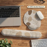 Beige desk mat with fine botanical line drawings and soft abstract shapes on a light neutral background.