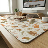 Cream desk mat with a woodland animal pattern featuring foxes, bunnies, mushrooms, berries, acorns, and sage leaves in soft green tones.