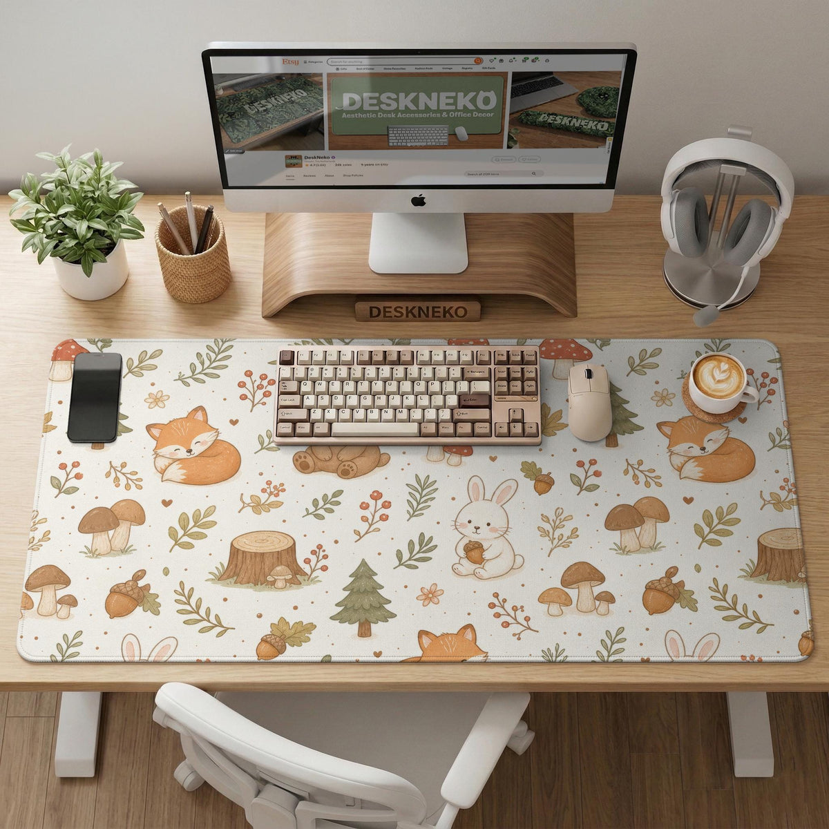 Cream desk mat with a woodland animal pattern featuring foxes, bunnies, mushrooms, berries, acorns, and sage leaves in soft green tones.