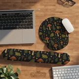 Dark botanical desk mat options with frogs, mushrooms, ferns, and acorns in brown and green tones, plus a matching keyboard wrist rest.