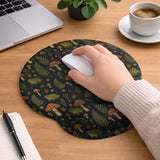 Dark botanical desk mat options with frogs, mushrooms, ferns, and acorns in brown and green tones, plus a matching keyboard wrist rest.