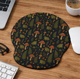 Dark botanical desk mat options with frogs, mushrooms, ferns, and acorns in brown and green tones, plus a matching keyboard wrist rest.