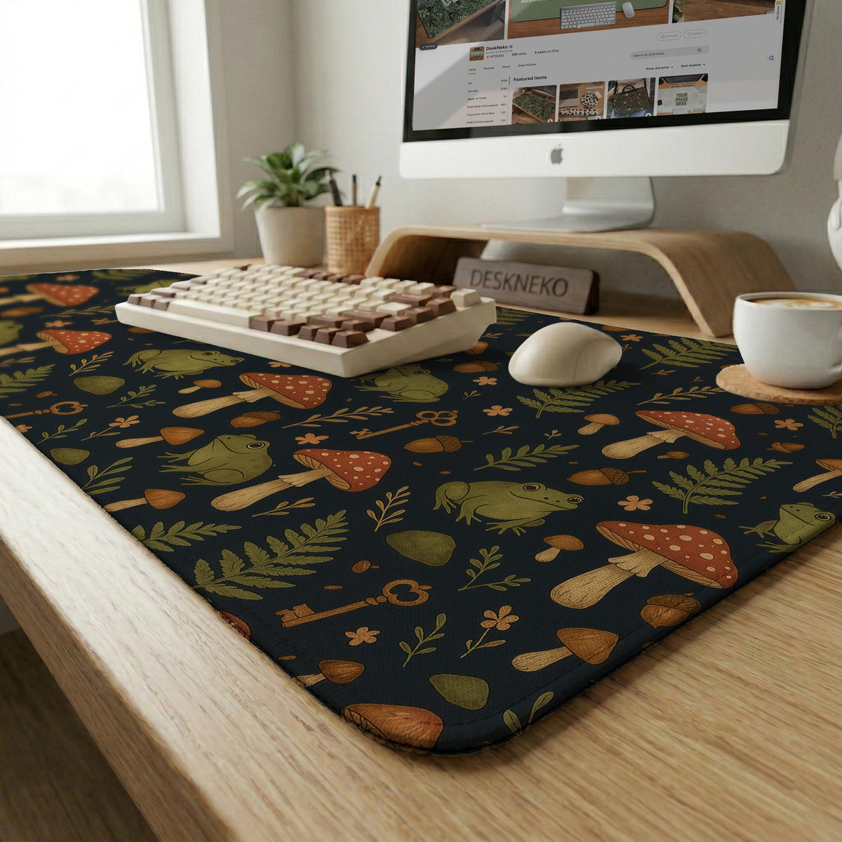 Dark forest-themed desk mat with an all-over pattern of frogs, mushrooms, fern leaves, acorns, tiny flowers, and antique keys.