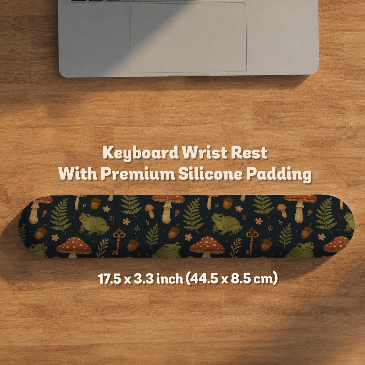 Dark forest-themed desk mat with an all-over pattern of frogs, mushrooms, fern leaves, acorns, tiny flowers, and antique keys.