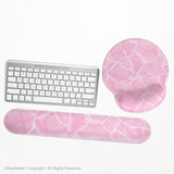 Soft pink mouse pad and wrist rest with a cloud-marble pattern, pale linework, and small star details.