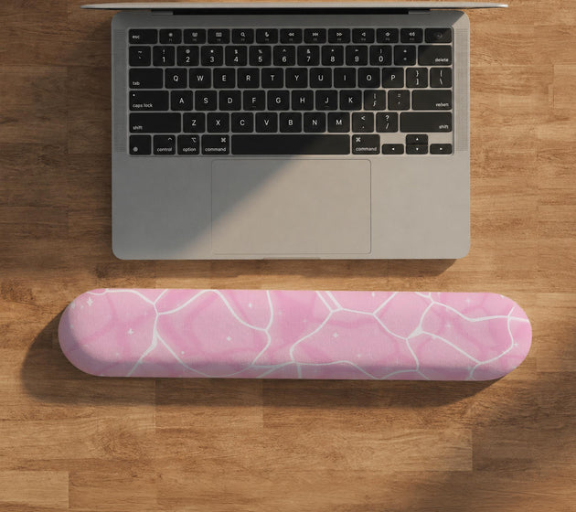 Soft pink mouse pad and wrist rest with a cloud-marble pattern, pale linework, and small star details.
