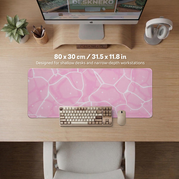 Pastel pink desk mat with a marble-style design, white flowing lines, and small sparkle accents.
