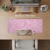 Pastel pink desk mat with a marble-style design, white flowing lines, and small sparkle accents.