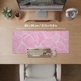 Soft pink desk mat with a kawaii cloud-marble pattern, white crackle lines, and small star accents.